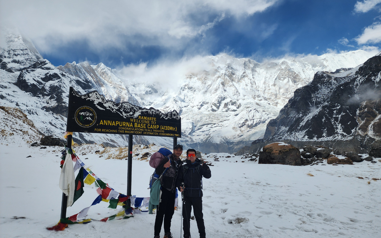 Suraj C.K. with trekkers and Himalayan mountains in the background